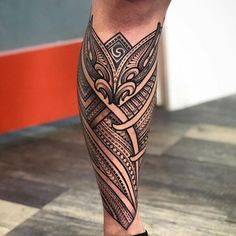 a man's leg with an intricate tattoo on it