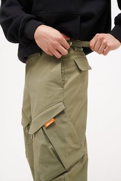 Introducing our first ever cargo pant, unlike anything on the market these are made from a soft matte polyester fabric with a soft touch interior making them perfect for that every single day wear. Designed with 2 huge angled cargo pockets to the thigh, these pockets expand out when harbouring your daily goods, closures are fixes with our 'balance' stick custom Creo zips & covered with asymmetric flaps. 2 pockets to the back side and an embroidered Creo Studios logo to the shin straps giving these a distinctive look for the wearer. The open bottom hem brings us back to 90s fashion inspiration with waist adjusters to help fit any size waist without a need for belt or tailoring. Very limited pieces, you know the drill... JAMES is 6'1 and wears a size large Nahome is 5'7 and wears a size larg 90s Fashion Inspiration, The Shins, Studio Logo, Cargo Joggers, Accessories Collection, Cargo Pant, 90s Fashion, Fashion Inspiration, Polyester Fabric