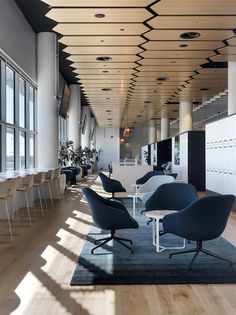 an empty office with chairs and tables in it