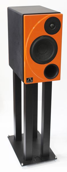 an orange and black speaker stands on top of each other with speakers attached to it