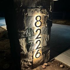 a lit up brick wall with numbers on it