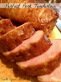 sliced ham sitting on top of a wooden cutting board