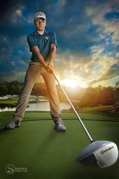 a man holding a golf club while standing on top of a green field next to a white ball