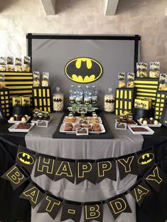 a batman themed birthday party with black and yellow decorations, desserts, and cupcakes