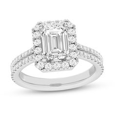 an emerald cut diamond ring with two rows of diamonds around it