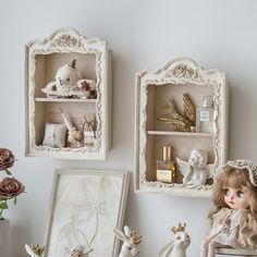 there are two shelves with dolls and other items on the shelf next to each other