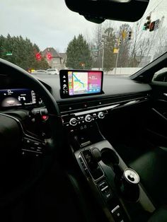 the interior of a car with an electronic device in the dash board and dashboard lights