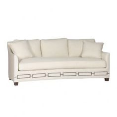 a white couch with four pillows on it