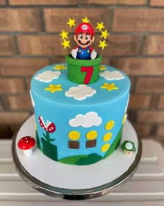 a blue cake with a mario on top