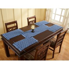 a dining room table with place mats on it