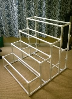 a white rack sitting on top of a carpeted floor