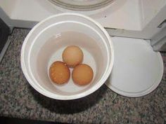 three eggs are in a bowl on the counter