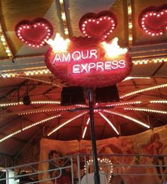 an illuminated sign that says,'i love your express'on the top of a carousel