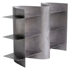 two metal shelvings sitting next to each other on a white background with no one in the photo