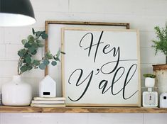 a wooden sign that says hey y'all on top of a shelf with other items