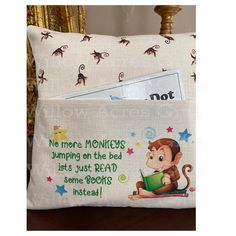 a pillow that has a monkey on it and some notes in the pocket next to it