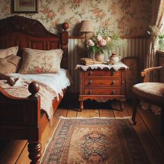 a bedroom with floral wallpaper and antique furniture