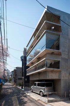 a car parked in front of a tall building