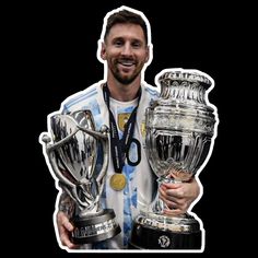 a man holding two trophies in his hands