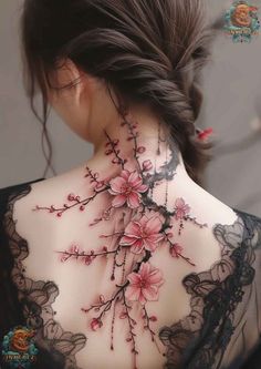 the back of a woman's neck with pink flowers on her chest and black lace