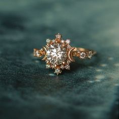 a close up of a ring with diamonds on the top and bottom, sitting on a black surface