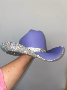 Inspired by Taylor Swift's Eras Tour, we custom made a purple hat with crystal rhinestones and a matching hat band. Sizing: This hat is a a one size fits all! The band on the inside is a stretchy band; all orders come with a custom Rhinestone Cowgirl dust bag and foam pieces that can be stuck behind the hat band to reduce the size. Blinged Out Cowboy Hat, Bejeweled Cowboy Hat Taylor Swift, Rhinestone Cowboy Hat Outfit, Eras Tour Hat Ideas, School Spirit Cowboy Hats, Bedazzled Fitted Hat, Cowgirl Hat Inspo Diy, Bedazzled Cowboy Hats, Decorated Hats Diy