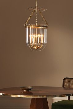 a chandelier hanging from the ceiling over a table