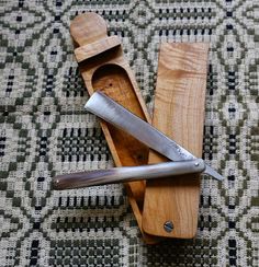 two knives in a wooden holder on a rug