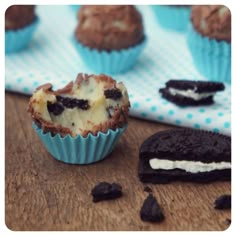 some cookies and muffins are on a wooden table with blue polka dot paper