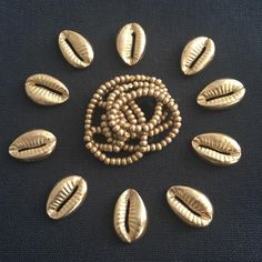 some gold colored beads are arranged in a circle