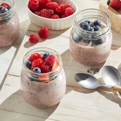 three small jars filled with fruit and oatmeal on top of a table