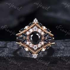 a black and white diamond ring sitting on top of a piece of cloth with the words,