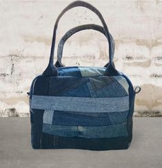 A patchwork denim handbag in a unique design made out of denim. It has cotton lining with a zipped pocket for keys or your cellphone. The bag also has one hidden zipped pocket on the outside. The patches are irregular which makes every bag unique. The approx. measurements of the bag is: Hight: 22 cm Widht: 28 cm Depht: 9 cm Handle lenght: 60 cm Carry the bag on your shoulder or arm or in one hand. This is one of a kind! Made out of upcycled denim jeans which will reduce the ecological footprint Denim Handbag, Ecological Footprint, Denim Handbags, Patchwork Denim, Top Handle Bags, Patchwork Jeans, Upcycled Denim, Denim Patchwork, Making Out