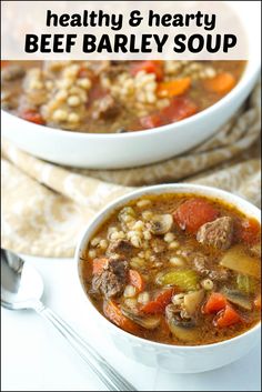 two bowls of beef barley soup with spoons on the side and title overlay