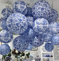 large blue and white paper lanterns hanging from the ceiling