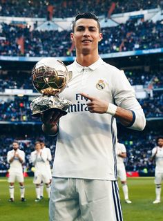 real madrid's forward cristianoo poses with the trophy