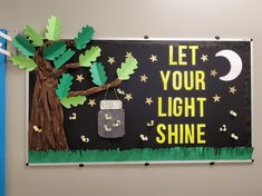 a bulletin board that says let your light shine with a tree and lantern hanging from it