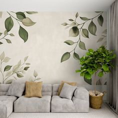 a living room with a couch, plant and wallpaper