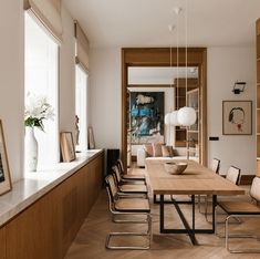 a dining room with wooden floors and white walls