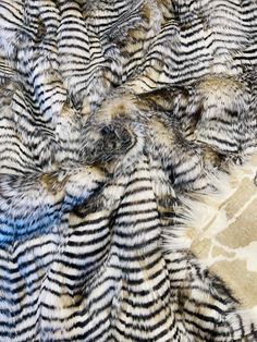 an animal fur texture with blue and black stripes on it's surface, as well as other patterns