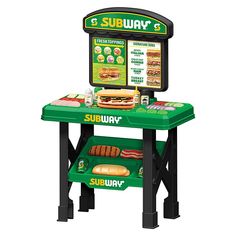 a green table with a sandwich display on it's top and two trays underneath