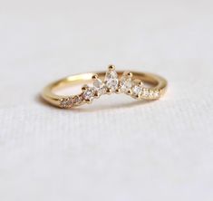 a gold ring with three diamonds on it