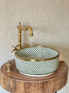 a bathroom sink sitting on top of a wooden table next to a faucet