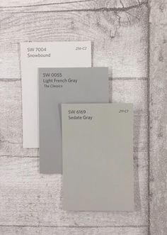 three shades of gray and white paint on a wooden surface with the words sw 005