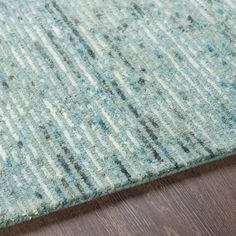 a blue rug on top of a wooden floor