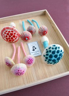 several different types of balls on display in a wooden box