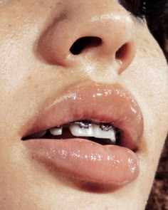 a close up of a woman's lips with white teeth