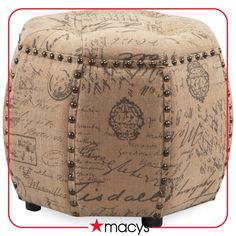 the ottoman is covered with writing and studded buttons