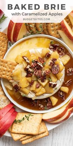 baked brie with caramelized apples and pecans in a white bowl surrounded by crackers