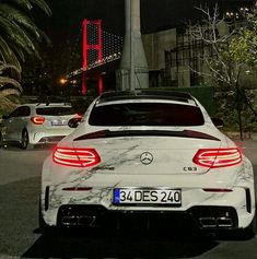 the back end of a white mercedes benz coupe